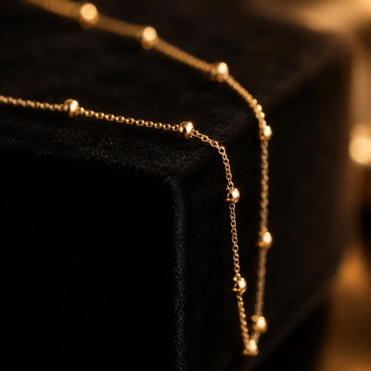 Gold satellite chain draped over black velvet