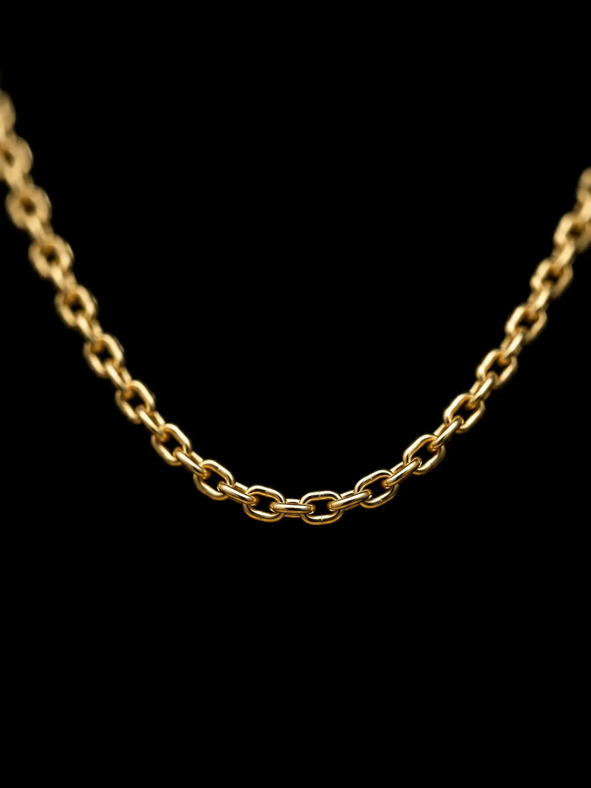 Macro of a fine gold-filled chain on black