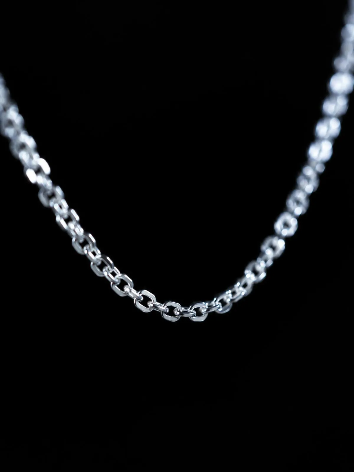 Macro of a fine sterling silver chain on black